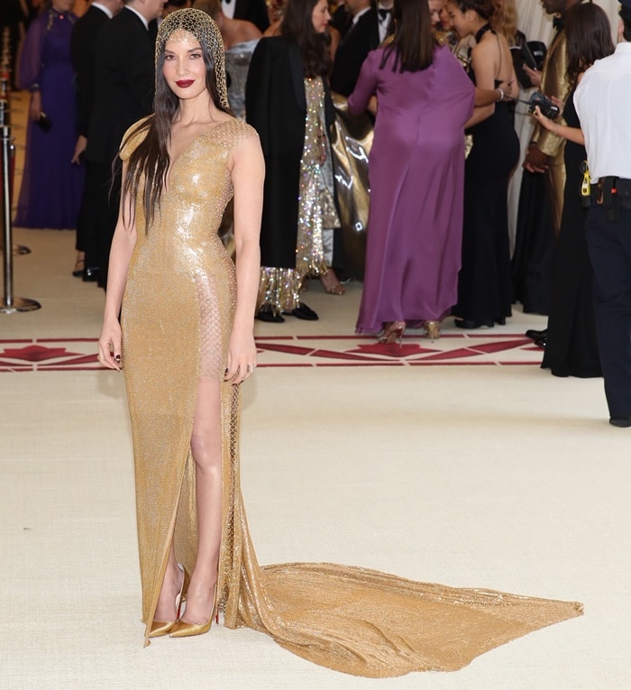 Olivia Munn shimmered in a sleeveless gold floor length dress from the HM Conscious Collection