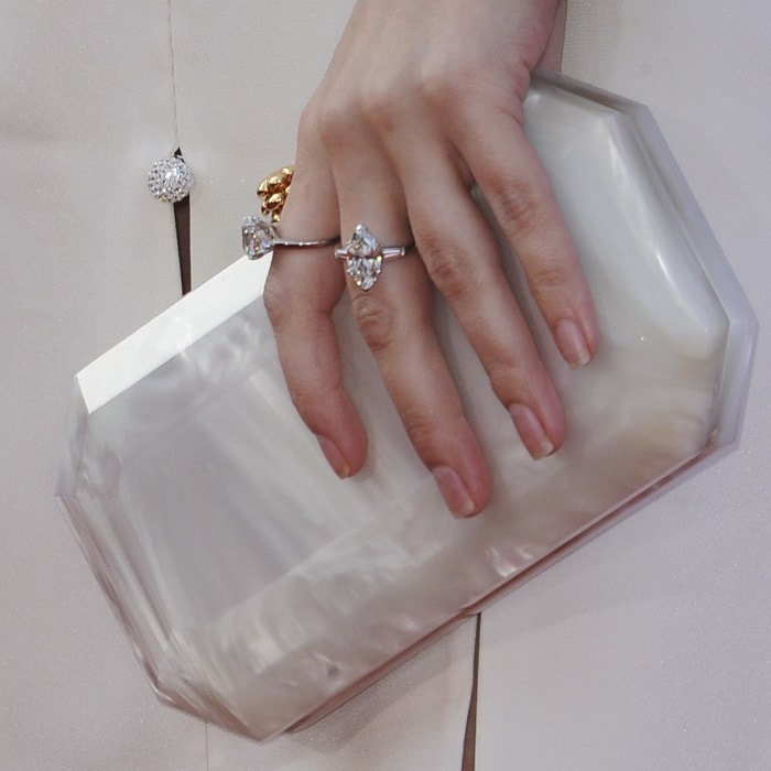 Anna Kendrick showing off her rings and small 'Perry' clutch from Tyler Ellis