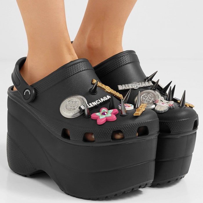 Made from black rubber, this lightweight pair is set on a towering foam platform and personalized with playful rubber charms, spikes and logo-embossed pins.
