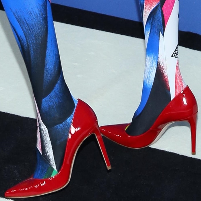 Gigi Hadid rocking flame patent Curvia pointy-toe pumps by Stuart Weitzman