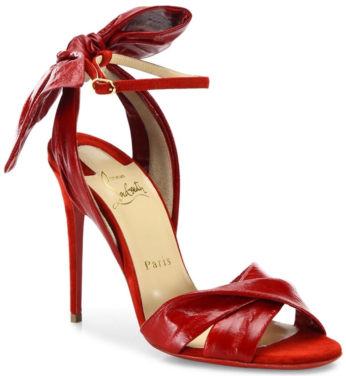 Ladylike bow accents sleek eel-and-leather sandals
