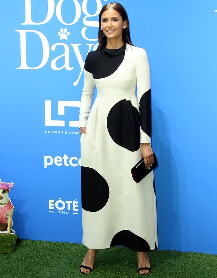 Nina Dobrev's dress has an exaggerated polka-dot print and is cut to an elegant ruffled high neck