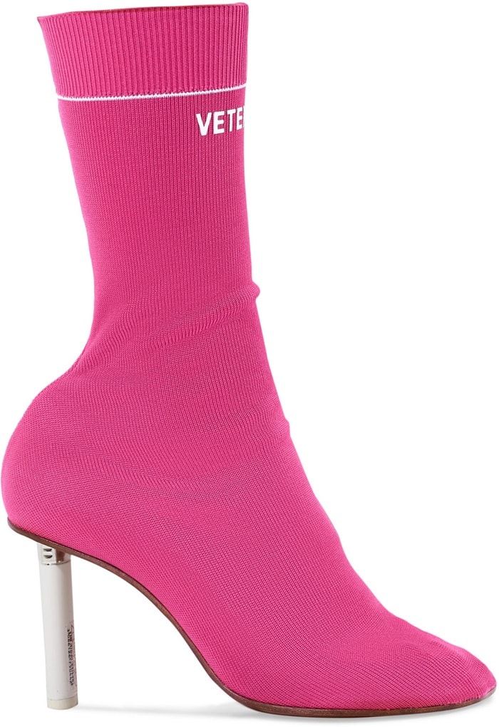 The pink stretch-jersey upper prominently features the label's name in sporty lettering across the cuff