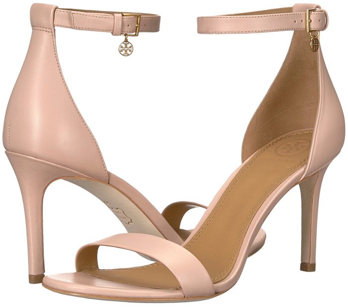 A double-T logo charm dangles brightly from the buckled ankle strap of a smart, wardrobe-staple sandal with a barely-there attitude