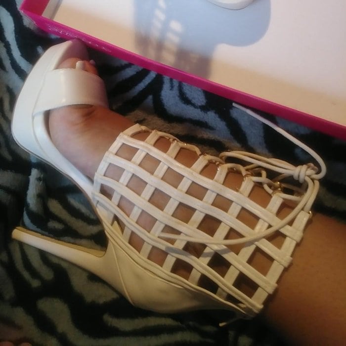 Sexy caged platform heeled sandal with front lace-up detail and back zip closure.