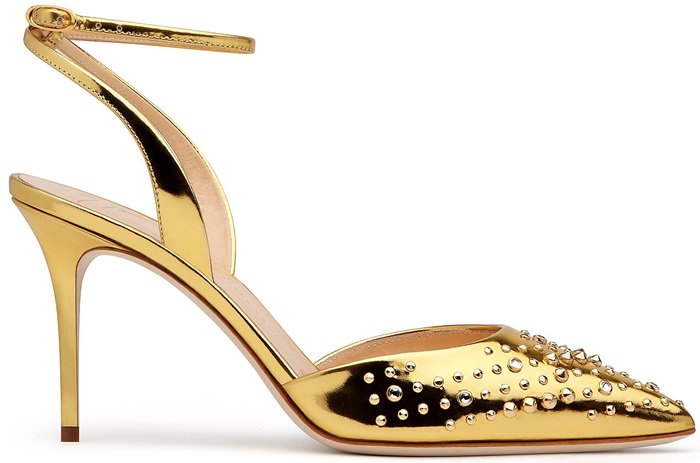 The mirrored golden leather is studded across the pointed toes, with low-slung uppers and a heel-fastening strap creating a streamlined silhouette