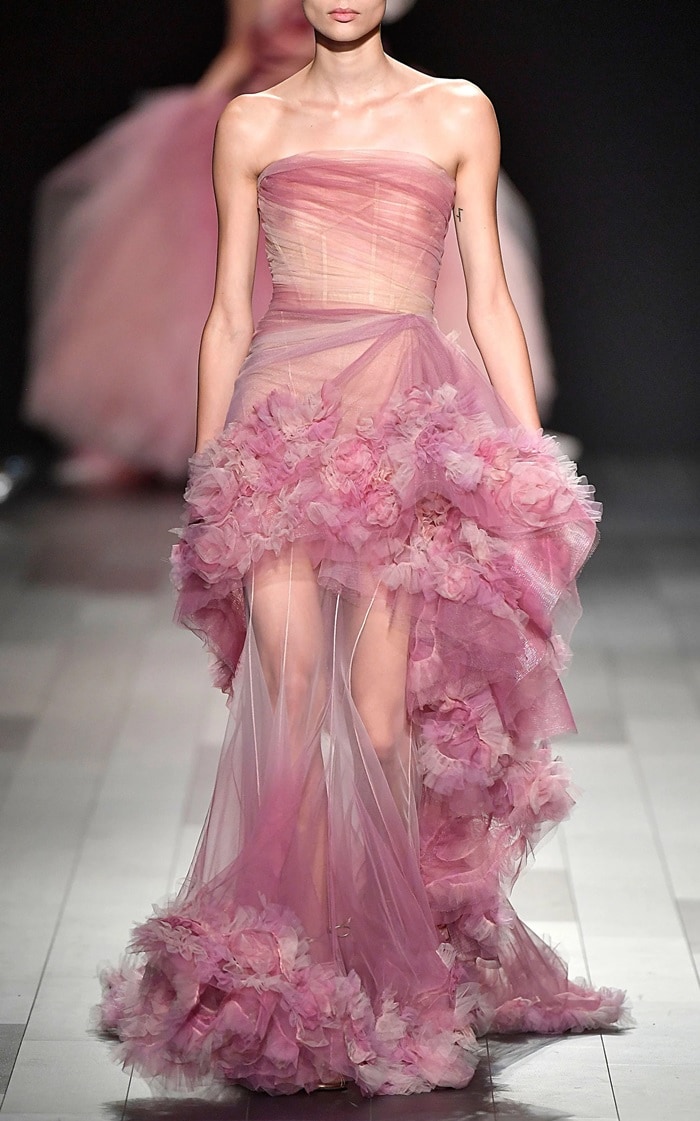 This Marchesa gown features a strapless neckline and draped tulle and silk organza floral texture