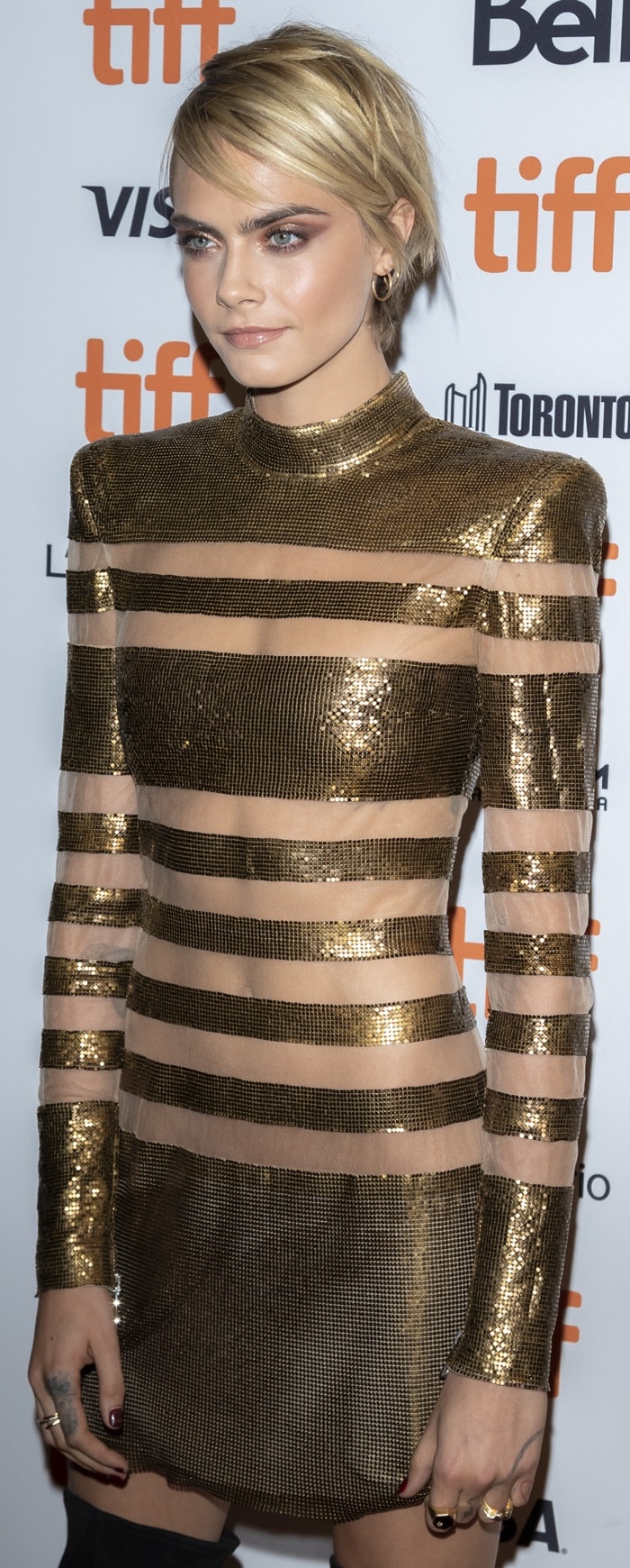 Cara Delevingne in a gold metallic mini dress from the Balmain Fall 2018 Collection