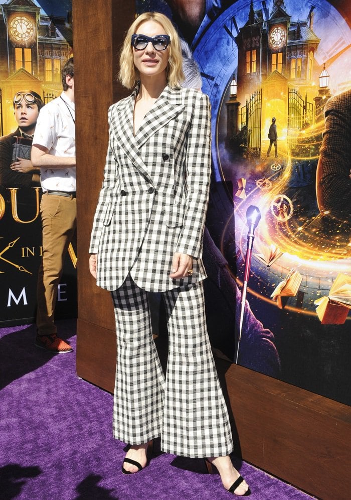 Cate Blanchett pairs her black block-heel sandals with a bold black-and-white plaid suit, creating a polished yet fashion-forward red carpet look