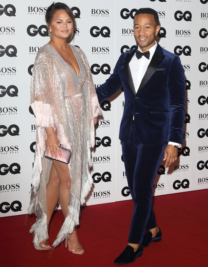 Chrissy Teigen flaunts her endless sexy legs in a draped metallic gown by Labourjoisie