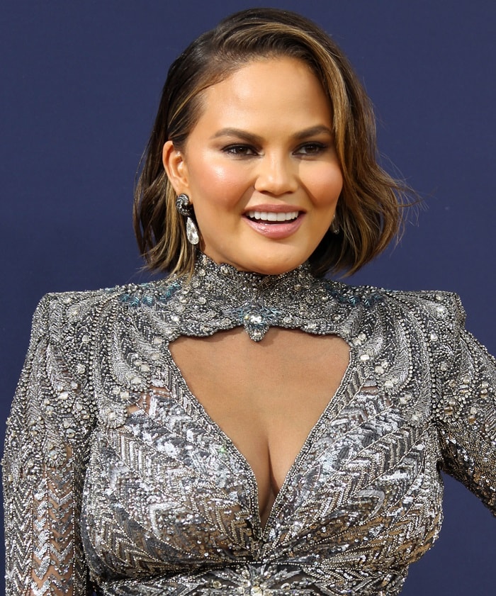 Chrissy Teigen flaunts her curves in an embellished gown from the Zuhair Murad Fall 2018 Couture Collection