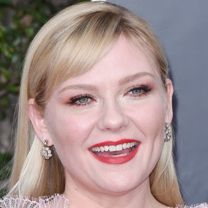 Kirsten Dunst flashes her signature smile and natural teeth while attending the 77th Annual Golden Globe Awards at the Beverly Hilton Hotel on January 5, 2020