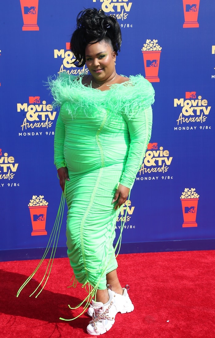 Lizzo styled a neon green Christopher John Rogers dress with white Flashtrek sneakers