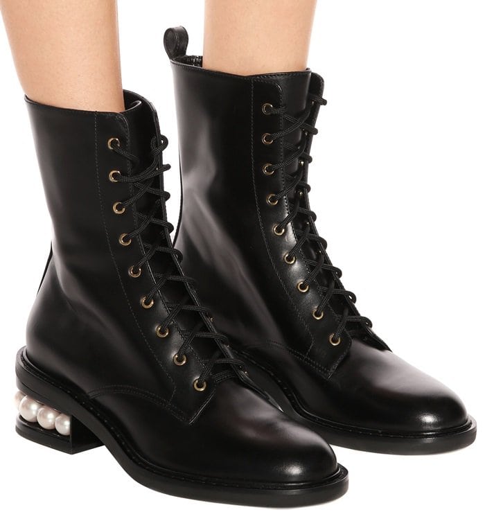 This classic lace-up biker style is crafted in Italy from glossy black leather and adorned with the label's signature faux-pearl embellished heel