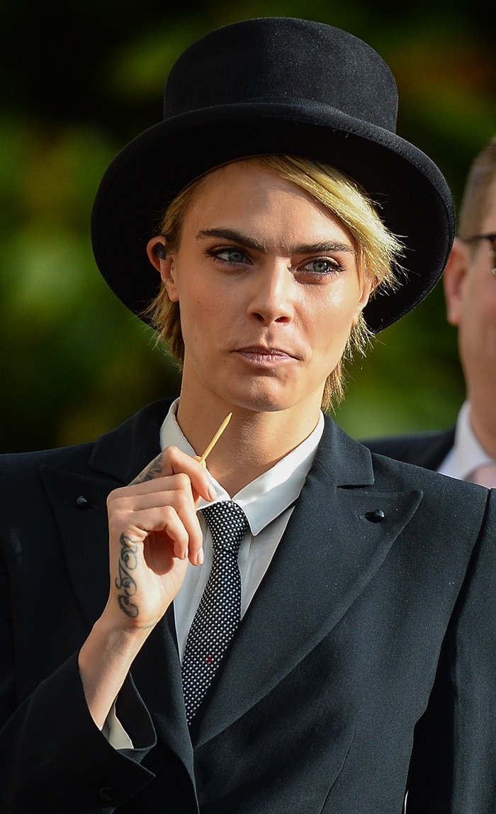 Cara Delevingne did her best to grab attention with a toothpick at the wedding of Princess Eugenie and Jack Brooksbank