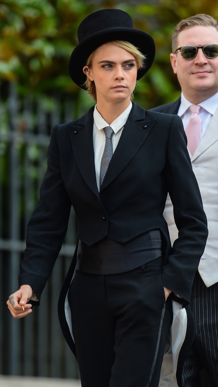 Cara Delevingne rocks a menswear-inspired Emporio Armani tuxedo styled with a show-stopping top hat