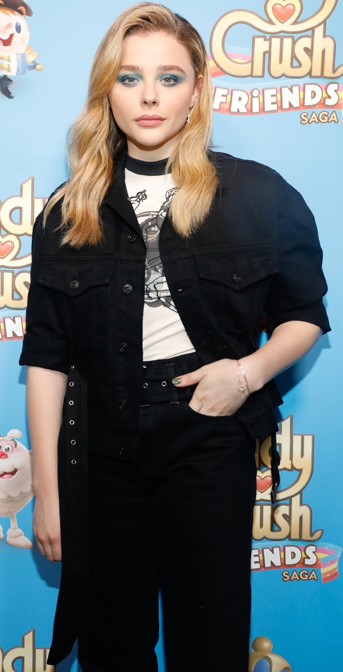 Chloë Grace Moretz wearing black cropped pants to the launch of the new Candy Crush Friends Saga game in New York City on October 11, 2018