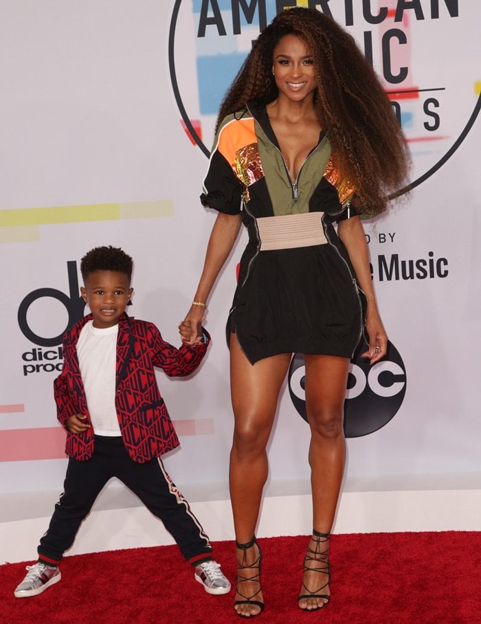 Ciara shows off her legs in strappy Dsquared2 Riri sandals while walking the AMAs red carpet with her son Future Jr., dressed in Gucci