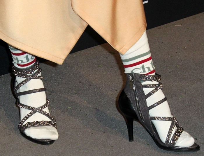 Debby Ryan in white socks and Victoria lizard-embossed leather sandals with mixed chain trim