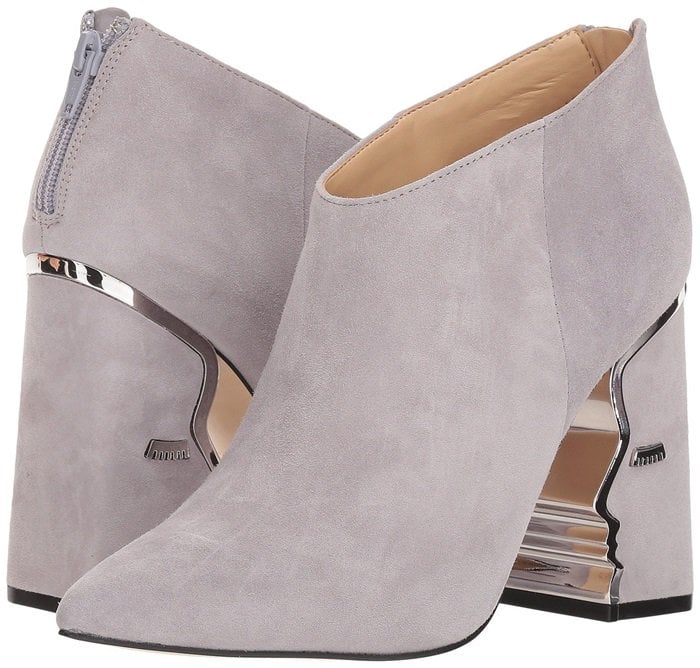 Heeled ankle boots with suede upper featuring face silhouette and hardware detailing