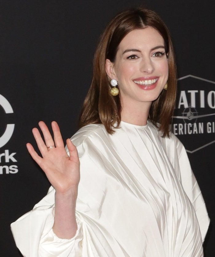 Anne Hathaway accessorized her minimalist Valentino dress with dazzling lab-grown yellow sapphire and diamond earrings by Anabela Chan
