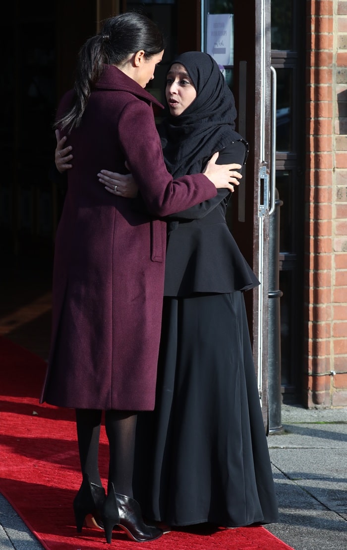 Meghan, Duchess of Sussex wore a burgundy Sallyet by Club Monaco dress with velvet collar detail