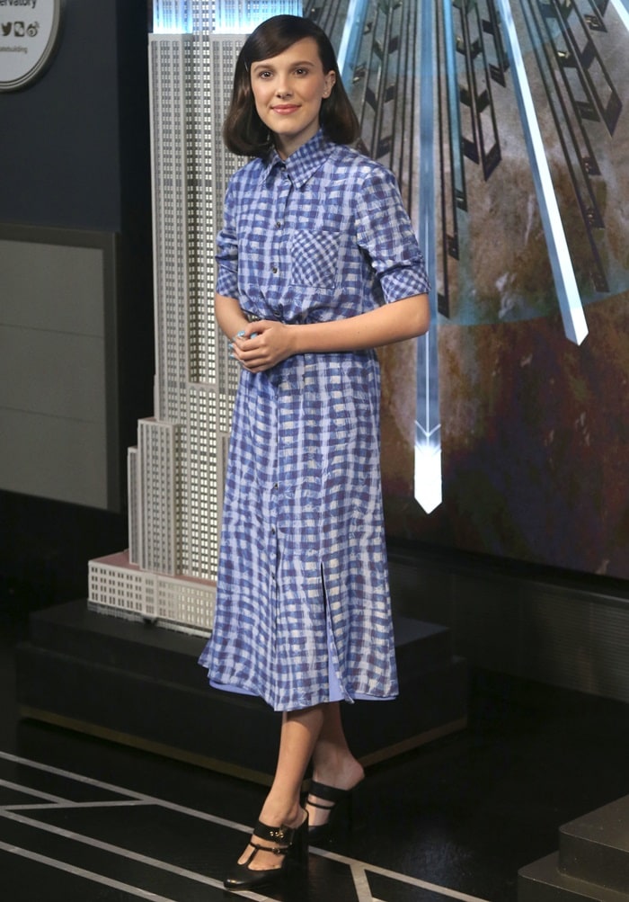 Millie Bobby Brown flashes her legs in a blue, plaid Altuzarra Spring 2019 dress