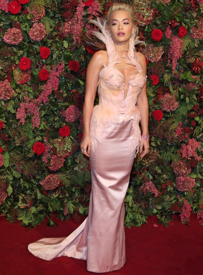 Rita Ora donned a vintage-inspired pale pink Thierry Mugler Couture gown featuring feather embellishments