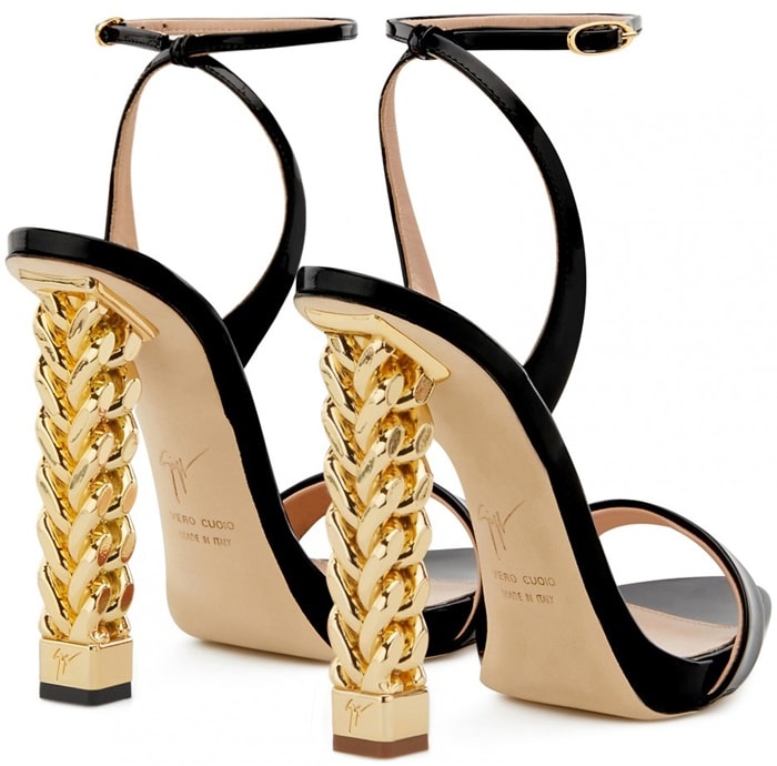 Crafted from luxurious black patent leather, these sandals are set on the iconic Chain chrome heel and fasten with a thin ankle strap and have a leather logo-adorned sole, the perfect intersection of Giuseppe Zanotti