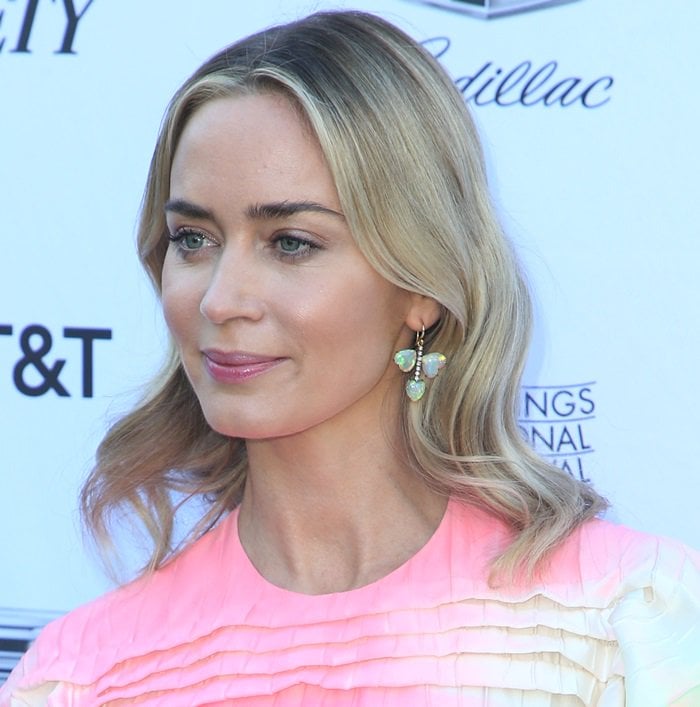 Emily Blunt’s voluminous blonde waves highlighted her green leaf Irene Neuwirth earrings