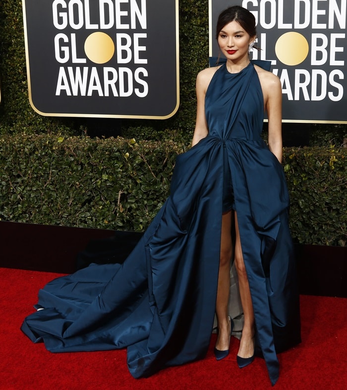 Gemma Chan stuns in a striking navy blue Valentino gown with a dramatic train at the 2019 Golden Globe Awards