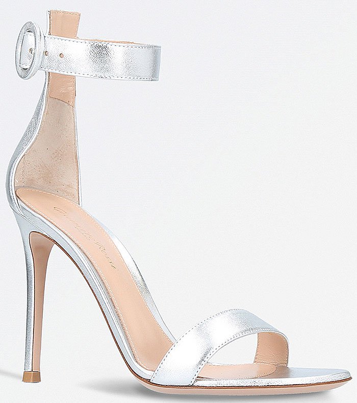 Gianvito Rossi's silver leather Portofino sandals feature the label's signature minimalist silhouette, combining delicate ankle straps with a sleek stiletto heel for timeless red-carpet appeal