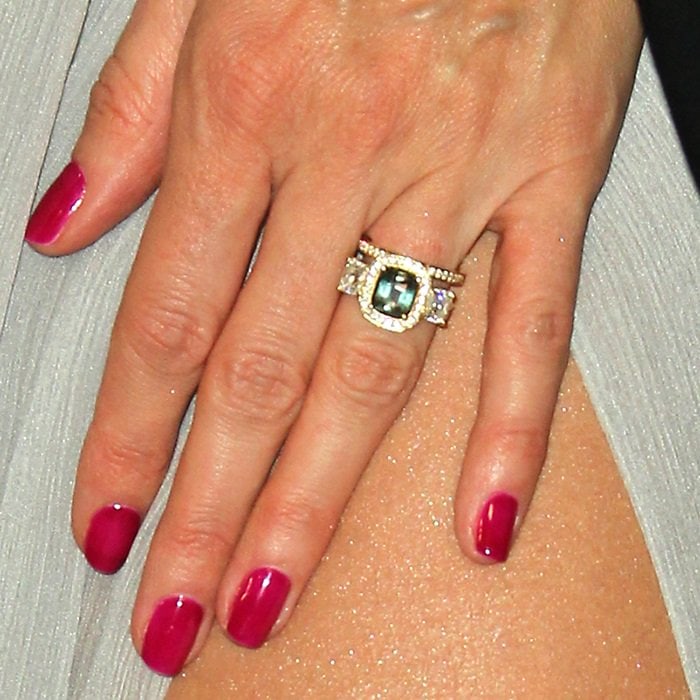 Heidi's eye-catching engagement ring featured a green sapphire center stone framed by diamonds on a yellow gold setting