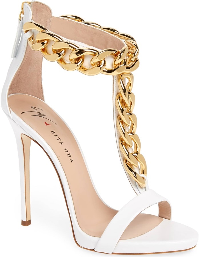 A statement-scale curb chain climbs the T-strap and rings the ankle of a daringly tall sandal crafted from optic-white calfskin