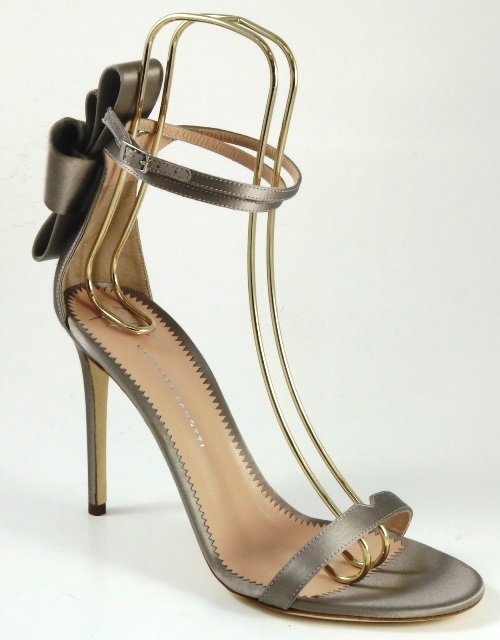 Crafted in grey satin, Giuseppe Zanotti's "Alina Bow" sandals featured a minimalist single-band silhouette elevated by a dramatic oversized bow and delicate ankle strap