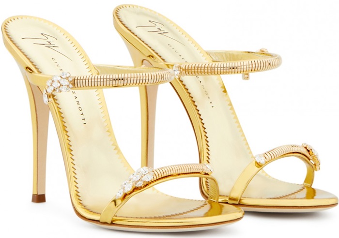 Made from gold shooting patent leather, these sandals are embellished with jewels on the straps