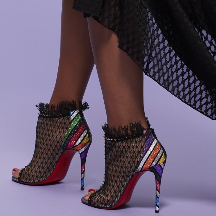 A sensual arch that follows through to a counter and 100mm slim stiletto heel both crafted in this season’s Velukid Strippyglitter brings back the 1970’s and disco nights