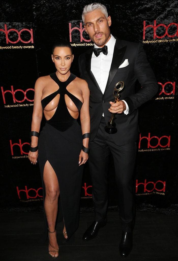 Kim Kardashian joined hairstylist Chris Appleton at the 2019 Hollywood Beauty Awards in an archival Thierry Mugler couture gown styled with barely-there Yeezy PVC sandals and original runway cuffs
