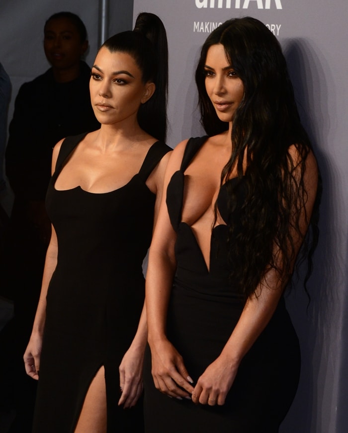 Kourtney and Kim Kardashian deliver matching Versace glamour in sleek black gowns at the 2019 amfAR New York Gala