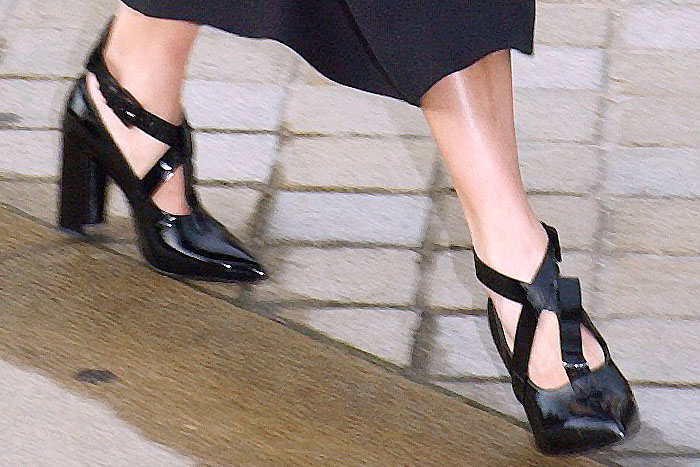 The center t-strap misaligned on one of Alicia Vikander's Louis Vuitton crisscross-strap patent pumps