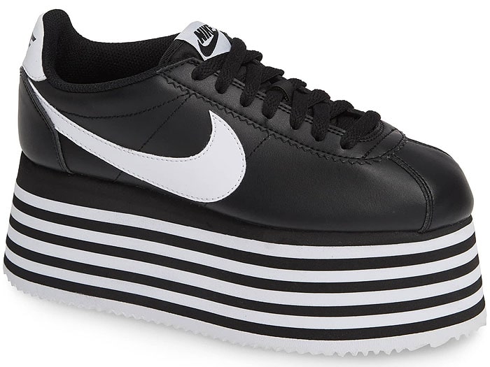 A stylishly striped platform sole gives a literal attitude boost to a sleek sneaker designed in collaboration with iconic sportswear brand Nike