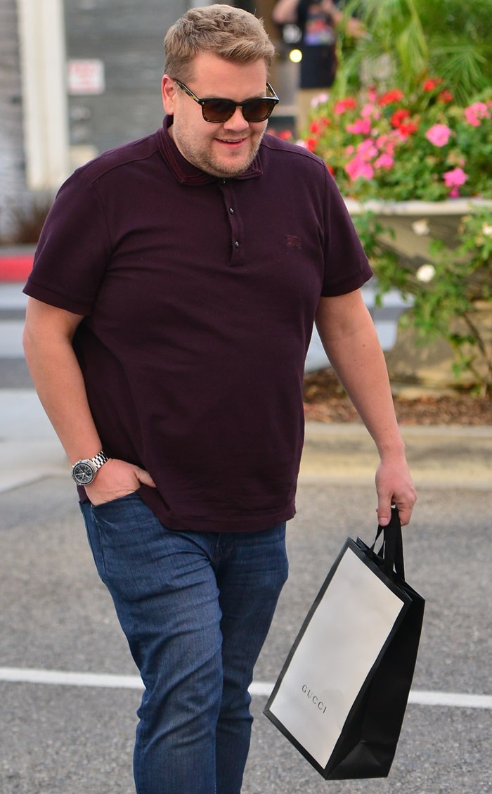 James Corden steps out carrying a Gucci shopping bag after a visit to the luxury house’s boutique, underscoring the brand’s instantly recognizable packaging and retail presentation