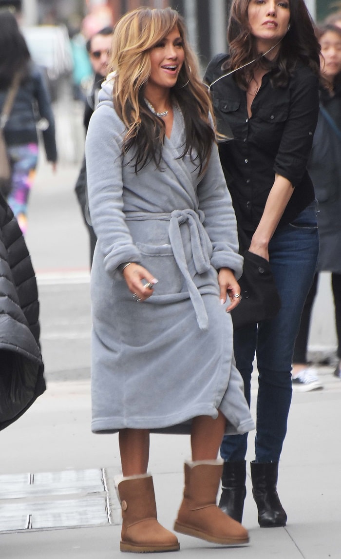 Jennifer Lopez keeps it cozy between Hustlers takes in a plush gray bathrobe paired with tan UGG Bailey Button II boots