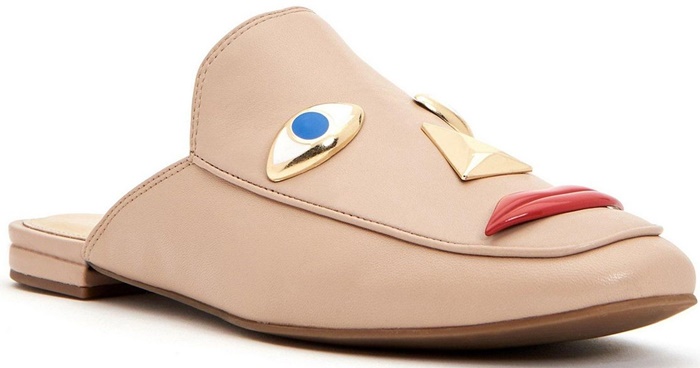 The profile of the nude Rue Face slip-on showcases the three-dimensional protruding nose and lip elements against the light leather