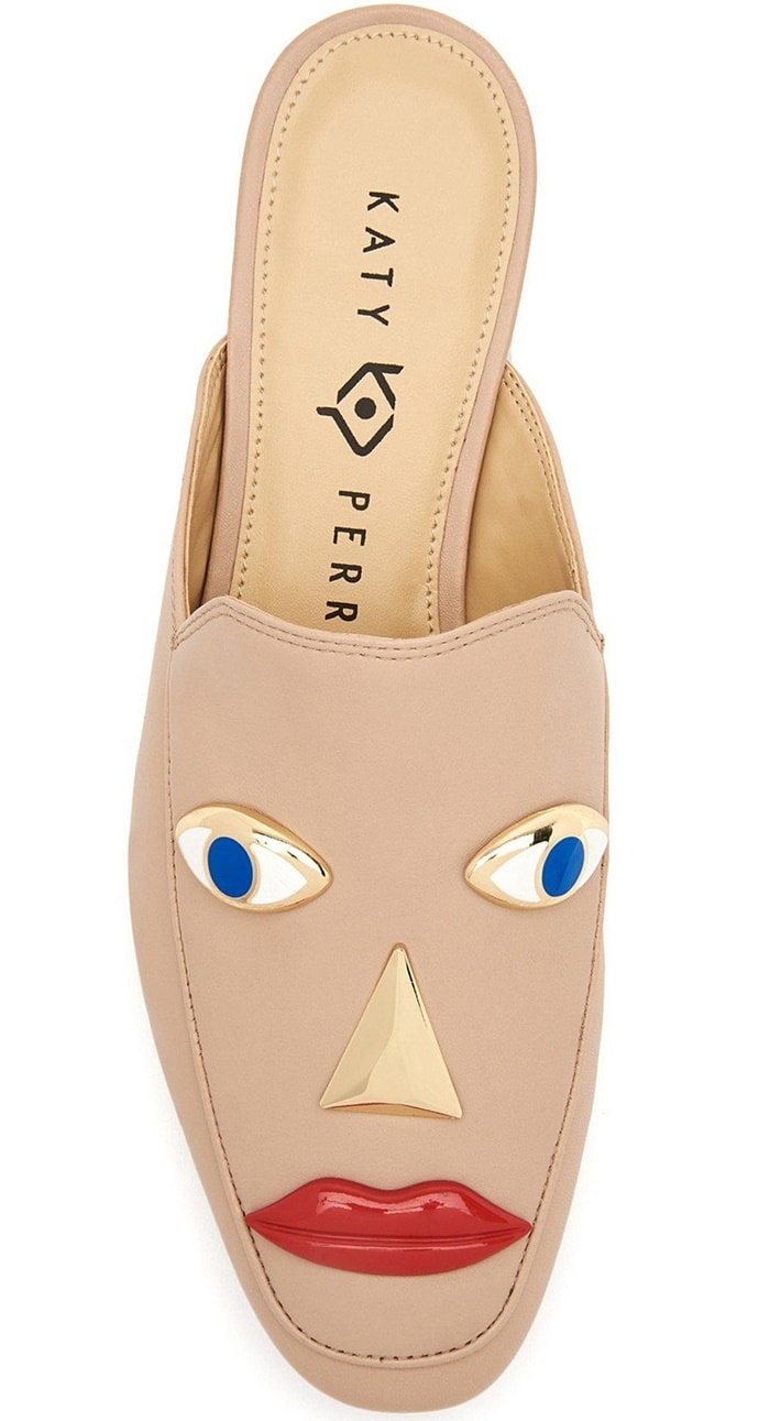 A top-down view of the Rue Face loafer in nude features a structured design with stylized gold-toned eyes and prominent red lips