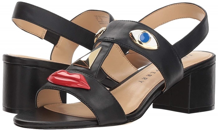 These black Ora Face sandals feature a block heel and the controversial facial motifs positioned over the open-toe straps