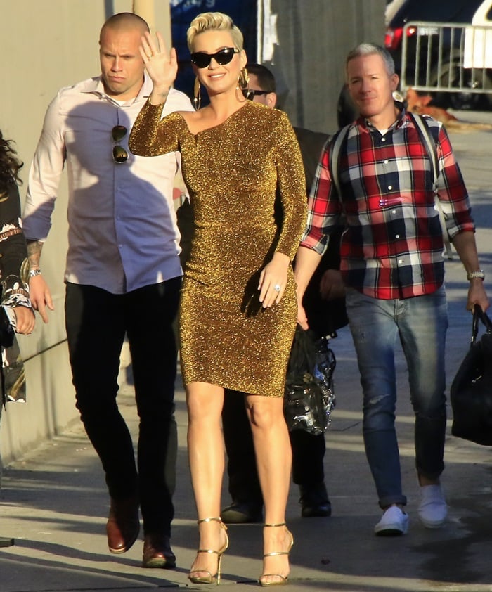 Katy Perry steps out for Jimmy Kimmel Live! on February 25, 2019, wearing a shimmering Solace London Liva dress styled with Giuseppe Zanotti “Harmony” sandals and sleek Versace cat-eye sunglasses