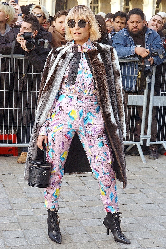 Noomi Rapace going heavy on the '80s aesthetic and a fur coat at the Louis Vuitton Fall 2019 fashion show