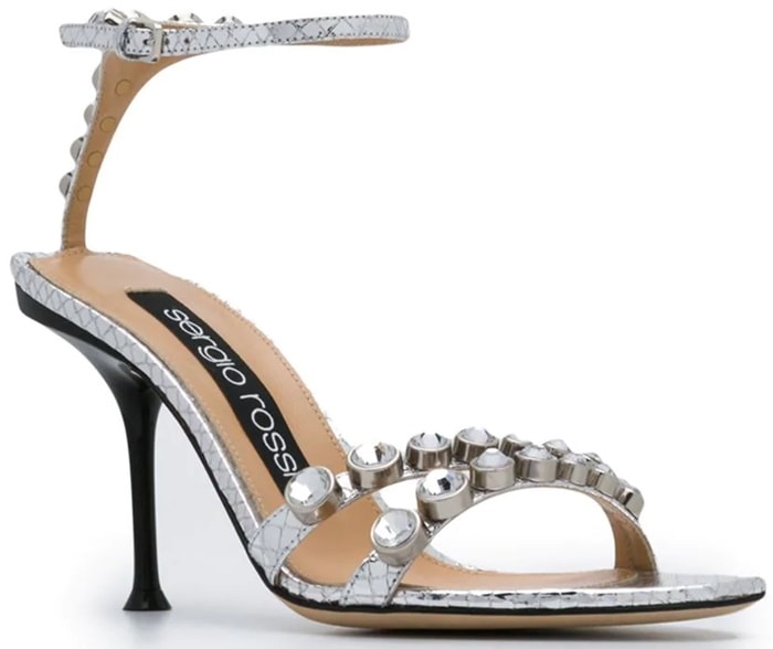 These silver-tone leather crystal embellished sandals feature an open toe, crystal embellishments, a branded insole, an ankle strap with a side buckle fastening, a high heel and a leather sole