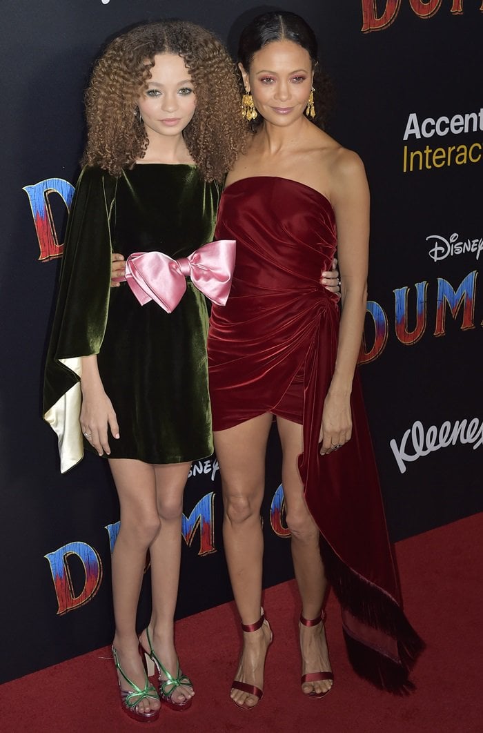 Nico Parker wears a forest-green Gucci velvet mini dress and coordinating sandals alongside Thandiwe Newton at the Dumbo world premiere